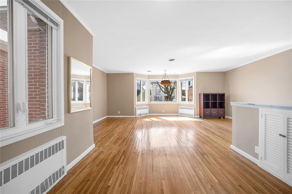 187 Irwin Street Brooklyn, NY 11235 - Photo 7 of 12 a view of a living hall with wooden floor and a window