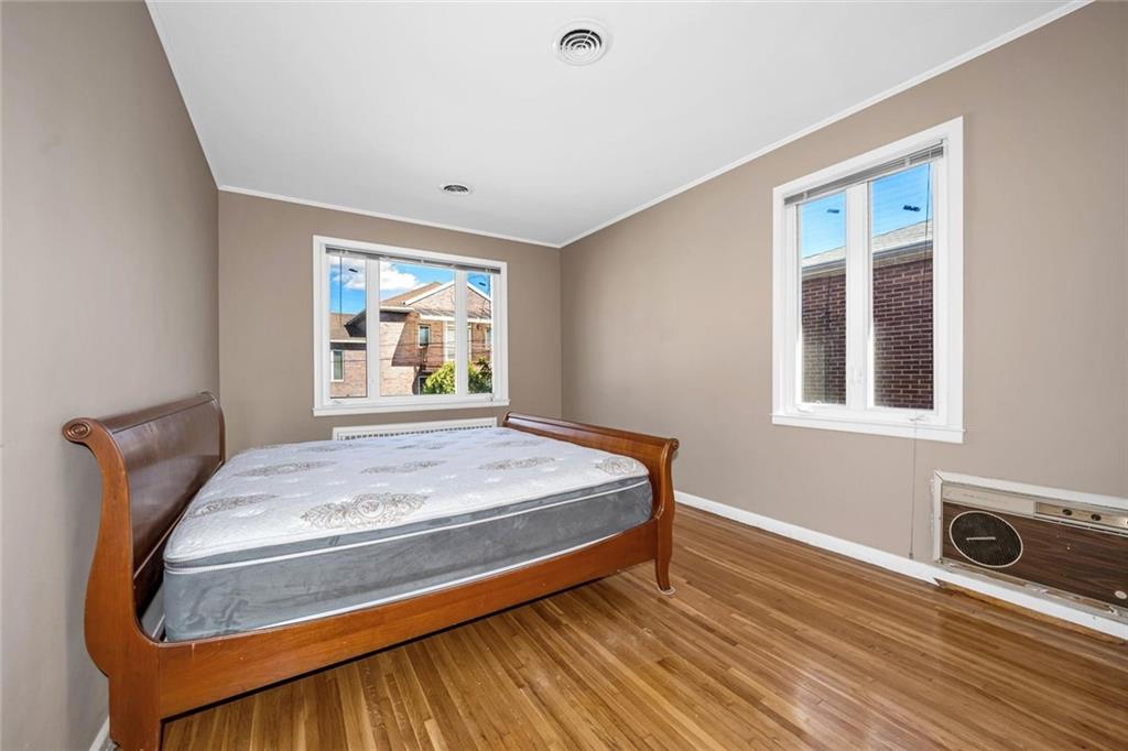 187 Irwin Street Brooklyn, NY 11235 - Photo 10 of 12 a bedroom with a bed and a window