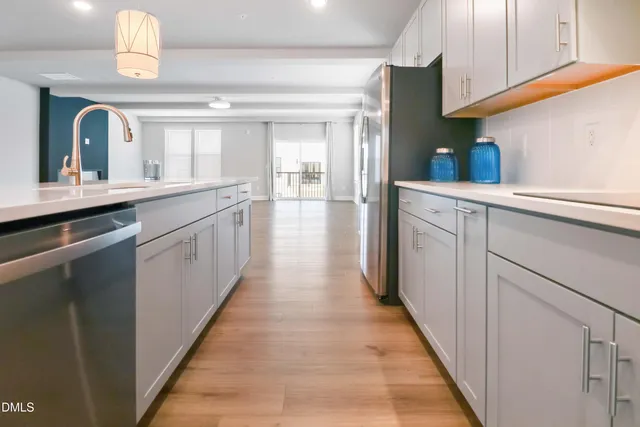 a kitchen with stainless steel appliances granite countertop a sink and cabinets