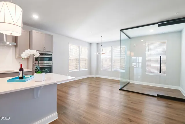 a view of kitchen with sink and refrigerator