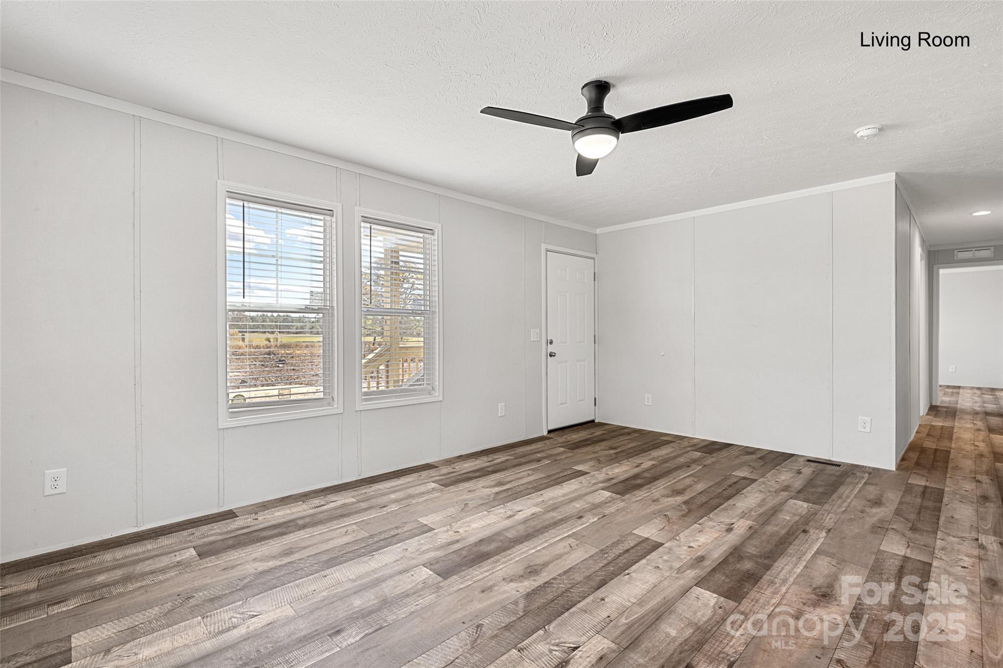 596 Jack Bone Hill Road Jefferson, SC 29718 - Photo 11 of 27 a view of empty room with wooden floor and ceiling fan
