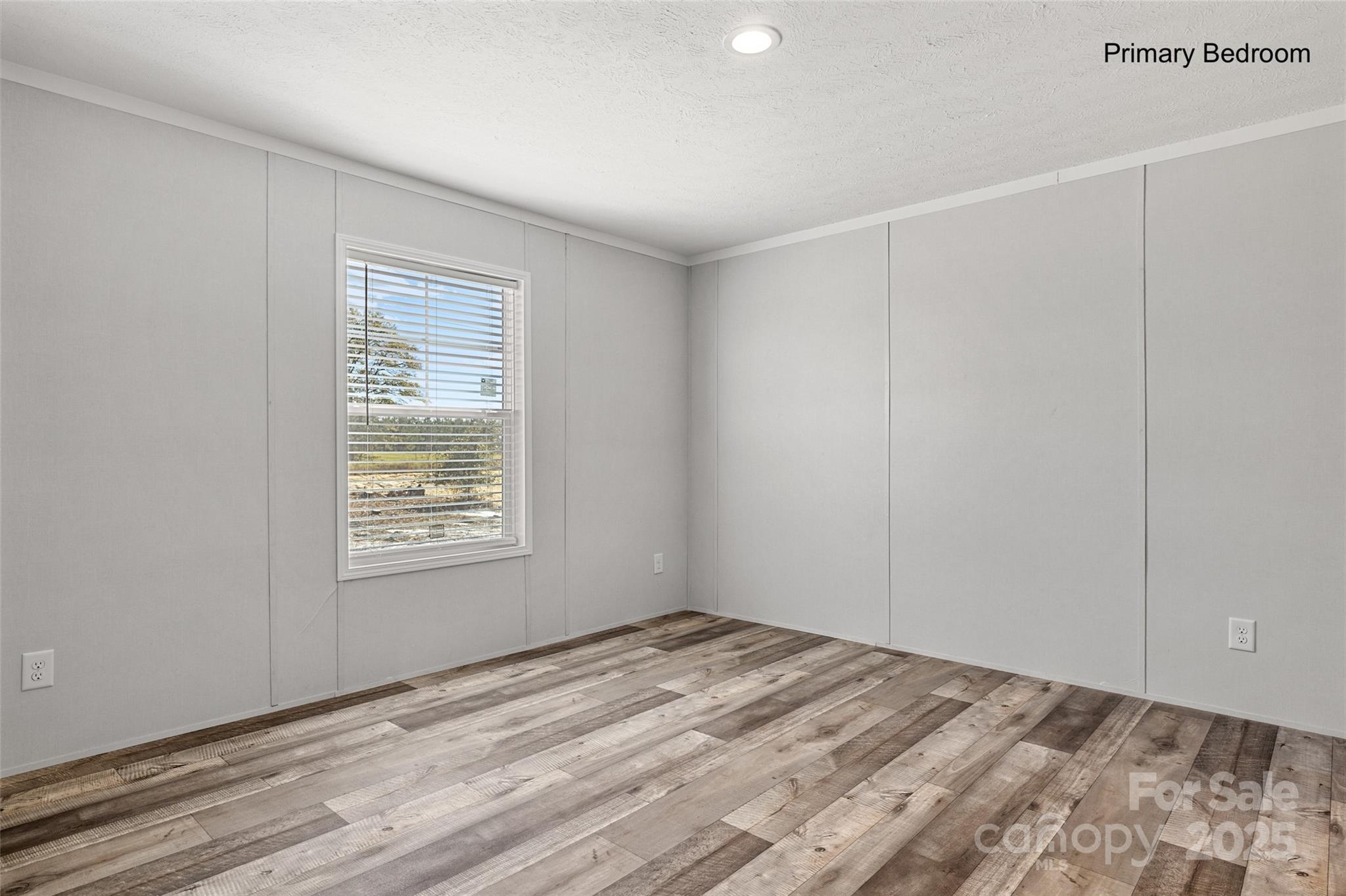 596 Jack Bone Hill Road Jefferson, SC 29718 - Photo 16 of 27 a view of an empty room with wooden floor and a window