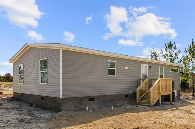a view of a wooden house with a yard