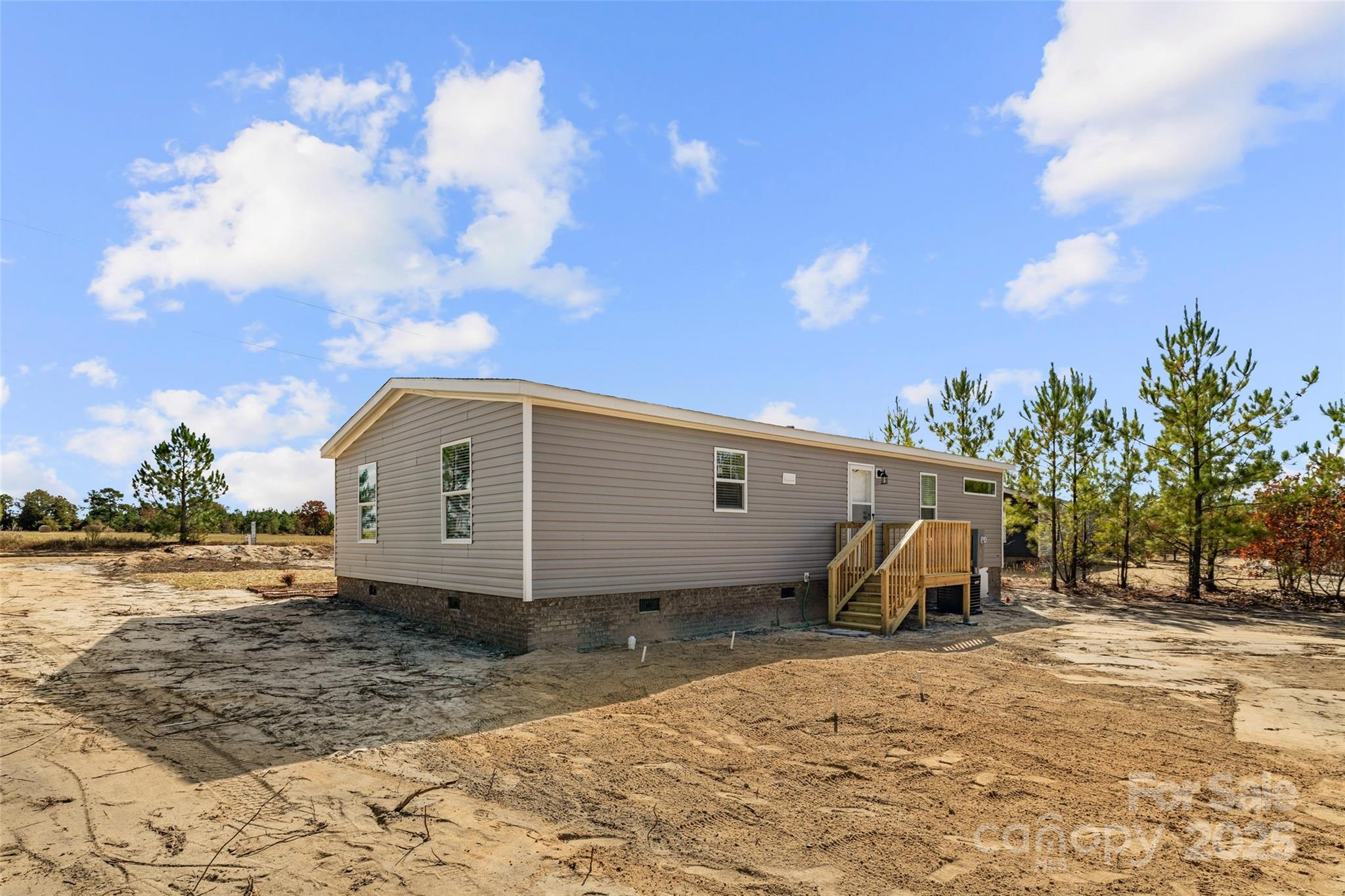 596 Jack Bone Hill Road Jefferson, SC 29718 - Photo 24 of 27 a view of a wooden house with a yard