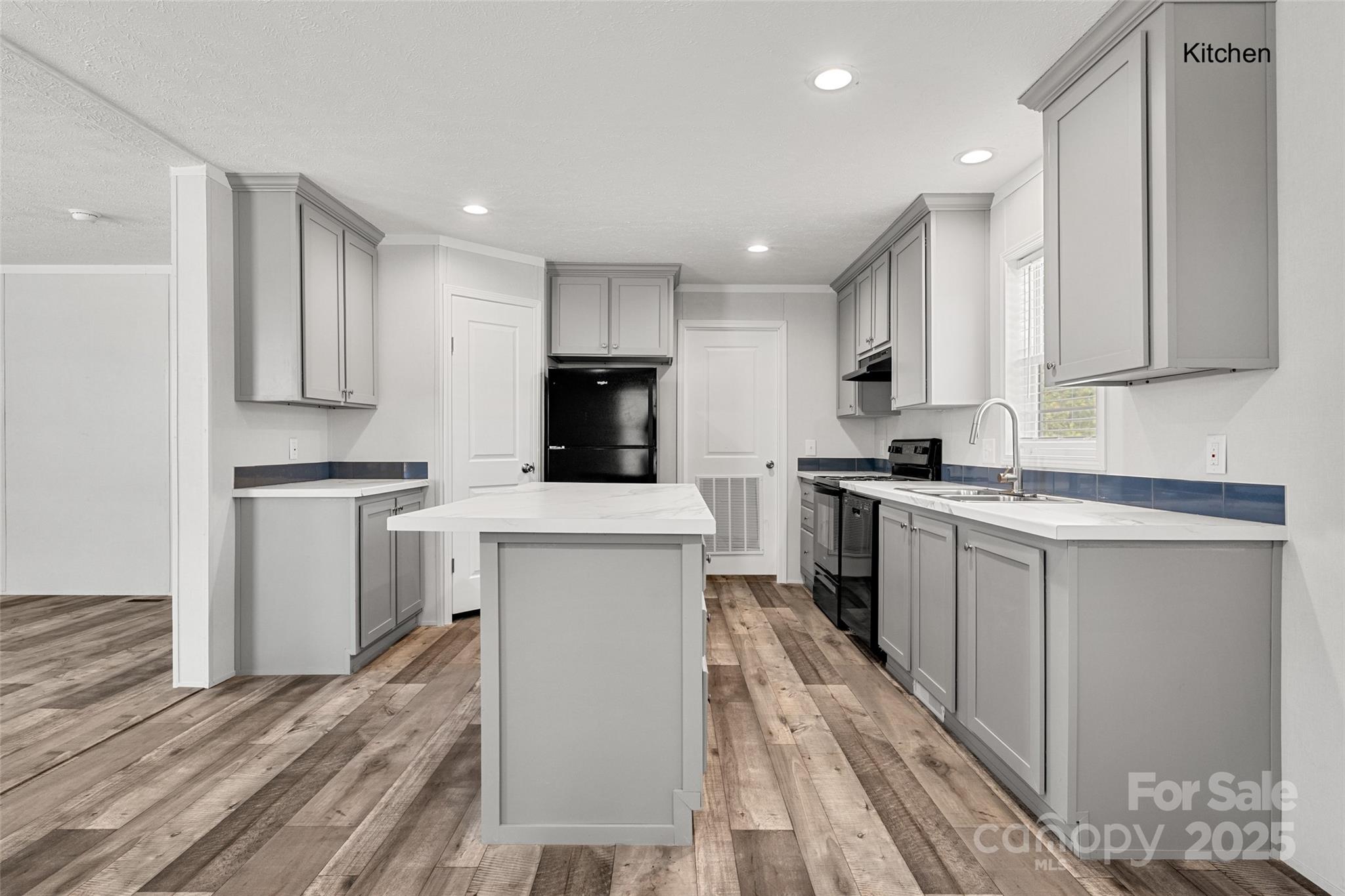 596 Jack Bone Hill Road Jefferson, SC 29718 - Photo 3 of 27 a kitchen with white cabinets and appliances
