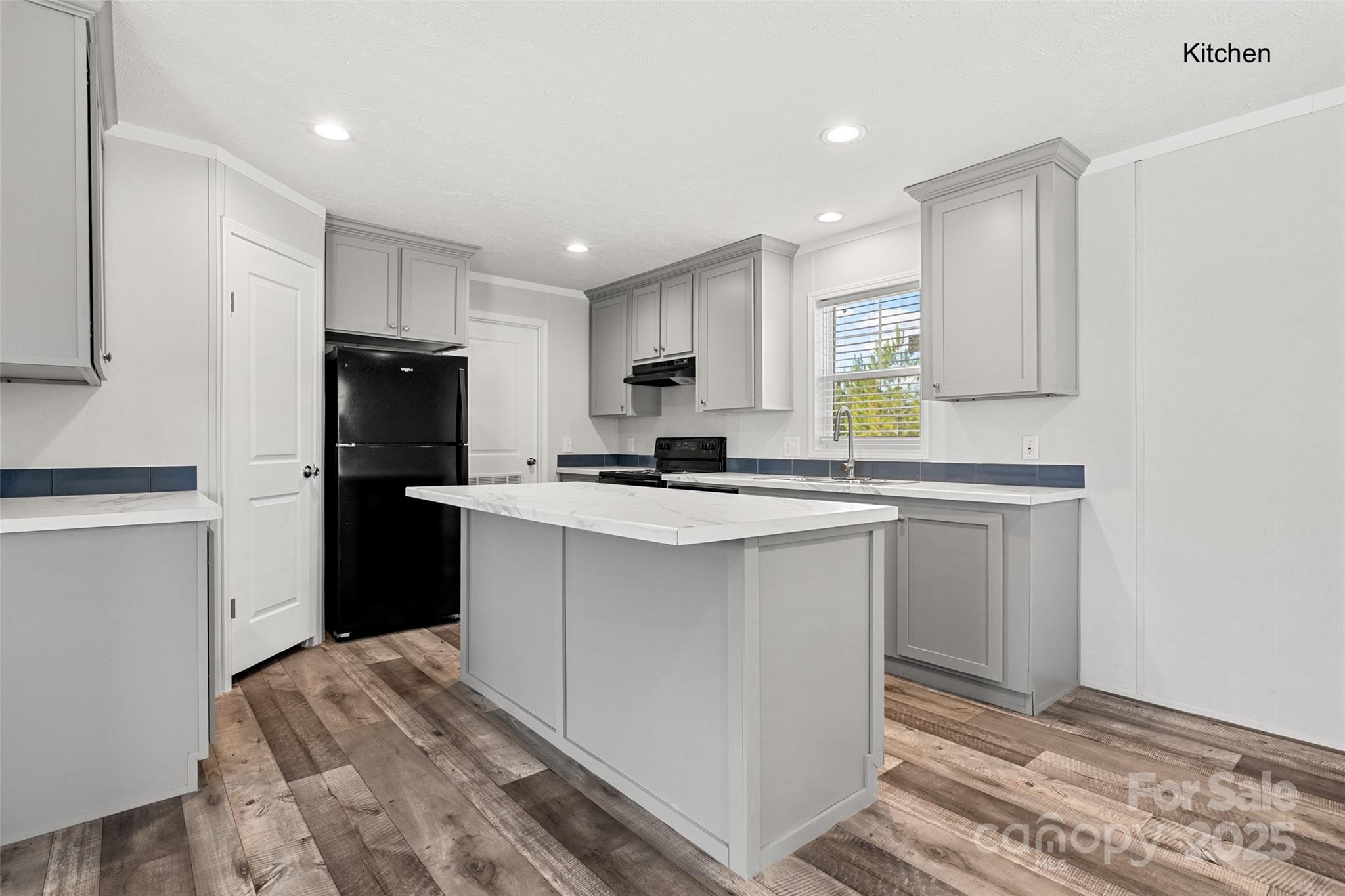 596 Jack Bone Hill Road Jefferson, SC 29718 - Photo 4 of 27 a kitchen with a refrigerator a stove top oven and white cabinets