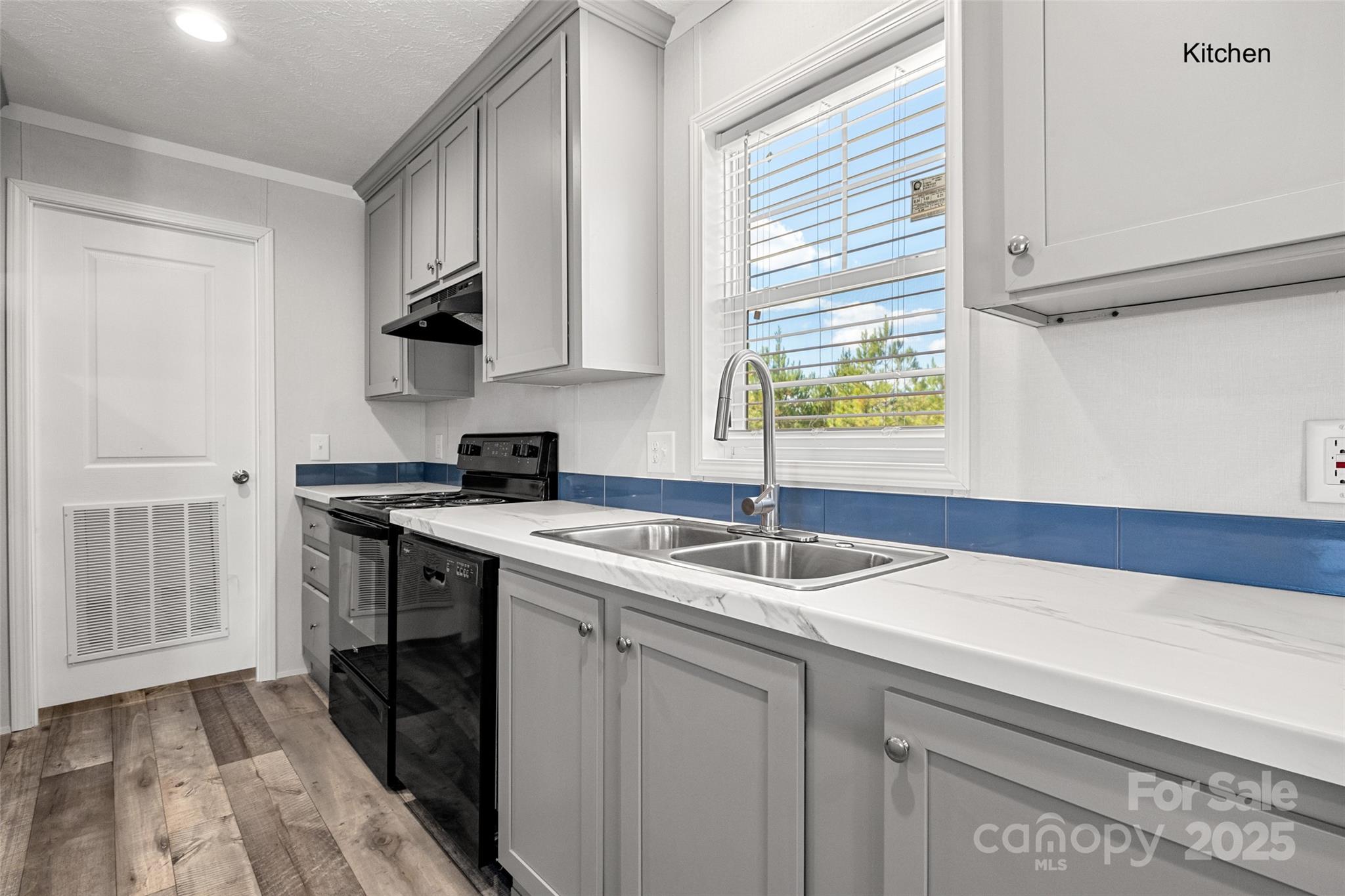 596 Jack Bone Hill Road Jefferson, SC 29718 - Photo 6 of 27 a kitchen with a sink stove and cabinets