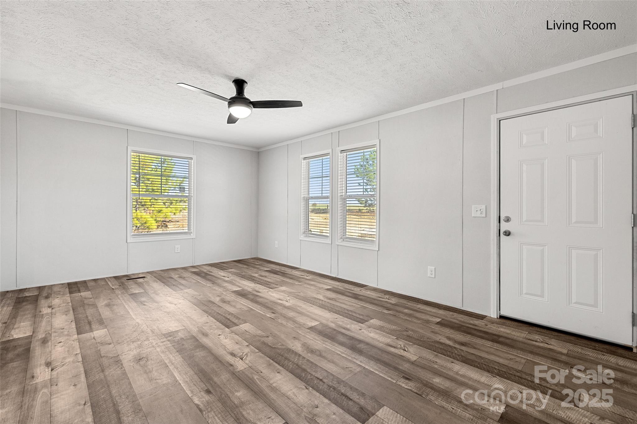 596 Jack Bone Hill Road Jefferson, SC 29718 - Photo 8 of 27 a view of an empty room with window and wooden floor