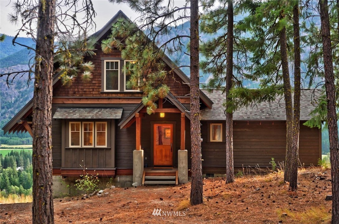 23 Bitterbrush Road Winthrop, WA 98862 - Photo 1 of 36 a front view of a house with a tree