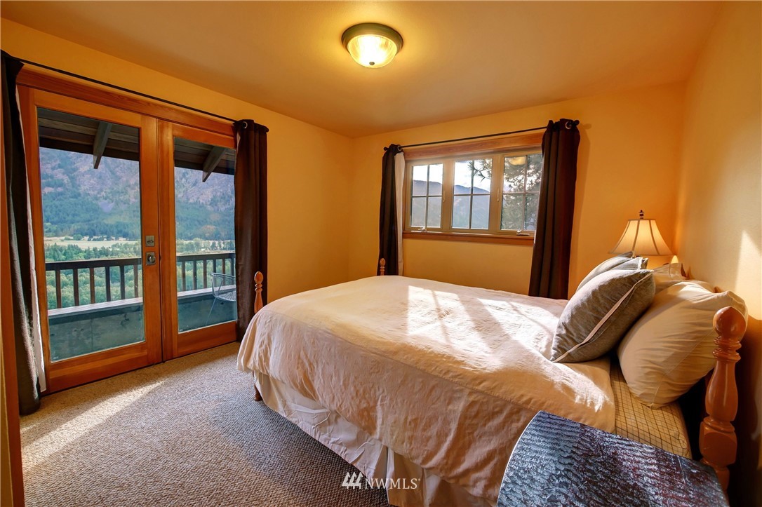 23 Bitterbrush Road Winthrop, WA 98862 - Photo 22 of 36 a bedroom with a bed and a large window