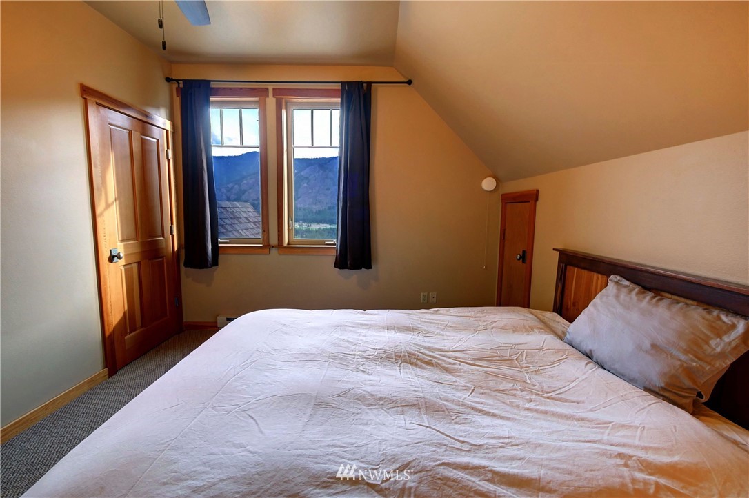 23 Bitterbrush Road Winthrop, WA 98862 - Photo 27 of 36 a bedroom with a large bed and a window