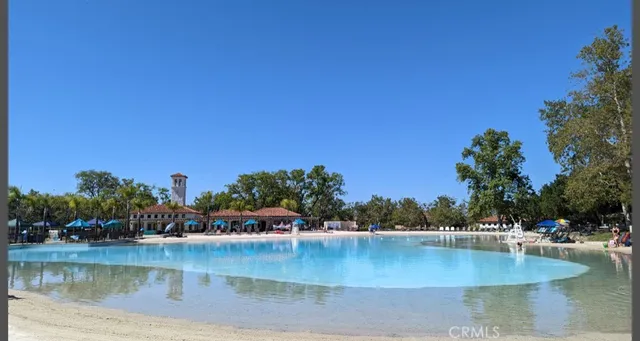 a view of a water pond with boats and trees in the background