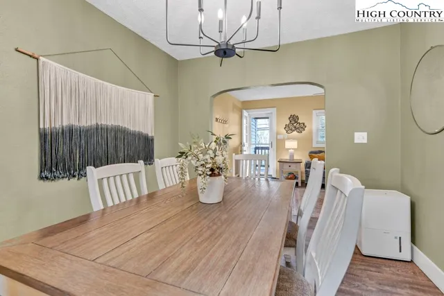 a view of a dining room with furniture and a chandelier