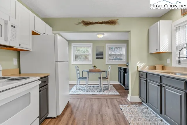a kitchen with a stove window and cabinets