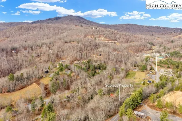 a view of a dry yard with mountains in the background