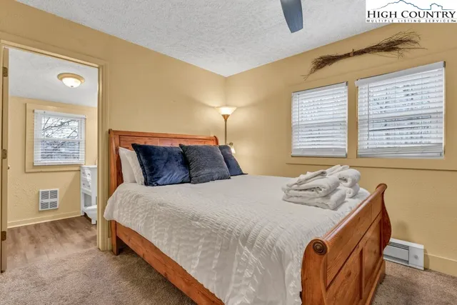 a bedroom with a bed and window