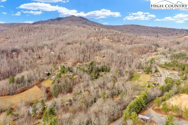 a view of a dry yard with mountains in the background