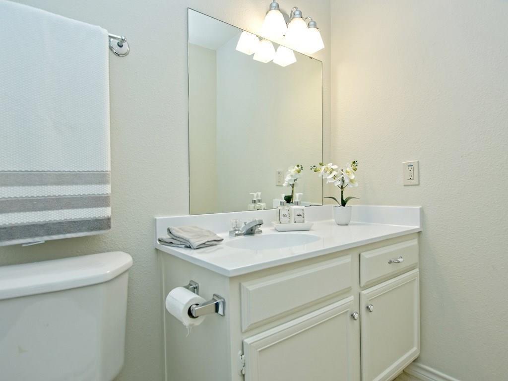 4159 Steck Avenue, Unit 278 Austin, TX 78759 - Photo 19 of 30 Bathroom featuring vanity, a textured wall, and suspended lighting
