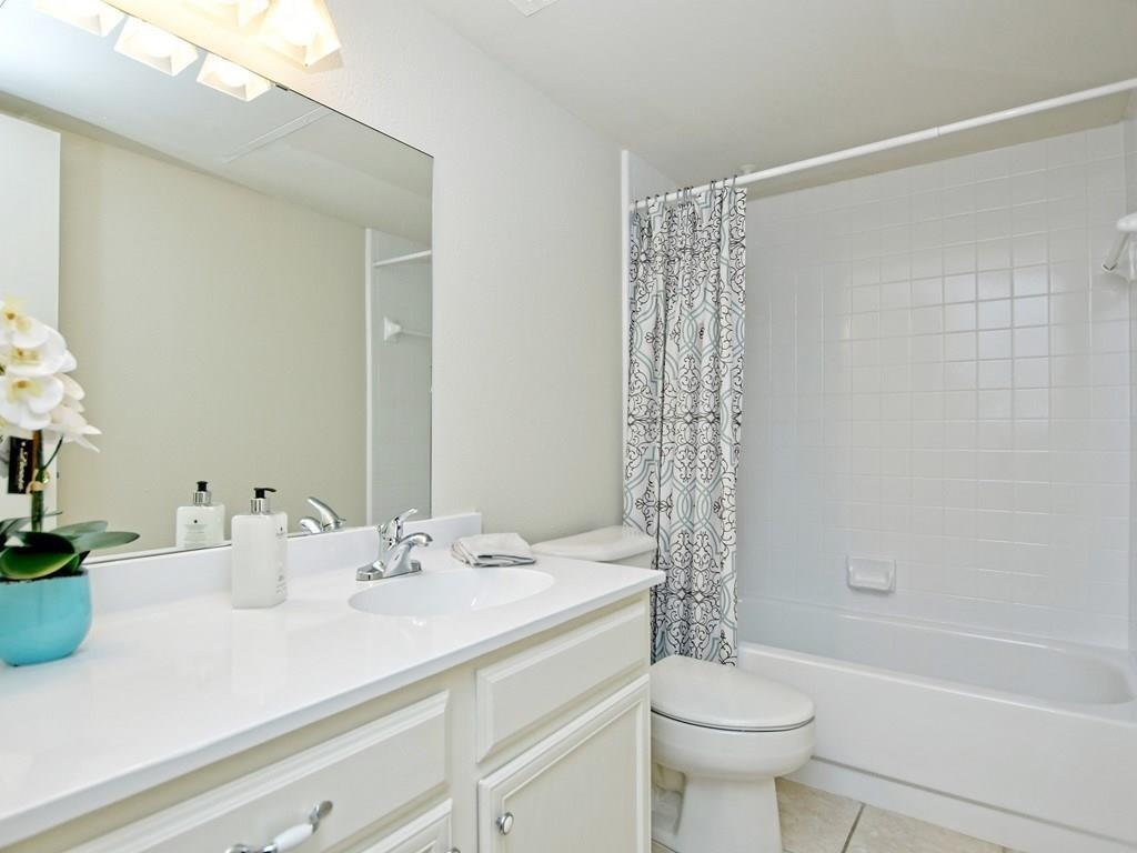 4159 Steck Avenue, Unit 278 Austin, TX 78759 - Photo 24 of 30 Bathroom featuring vanity, shower / bathtub combination with curtain, and light tile patterned floors