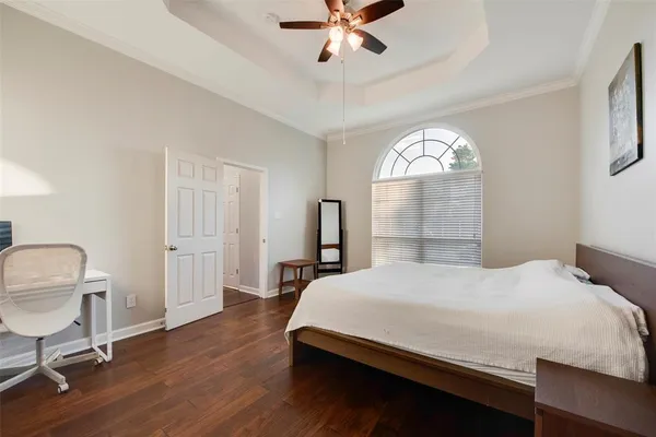 a bedroom with a bed and a chandelier