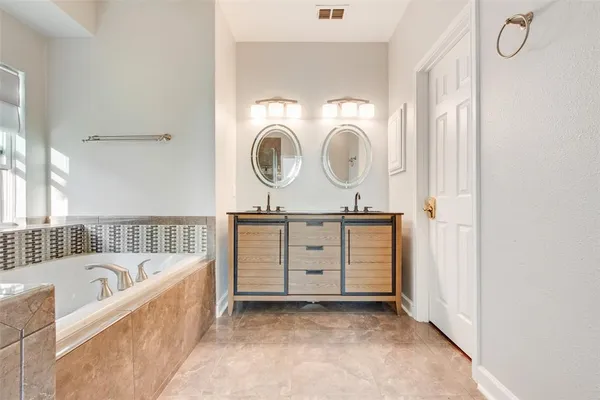 a bath tub sitting next to a bathroom sink
