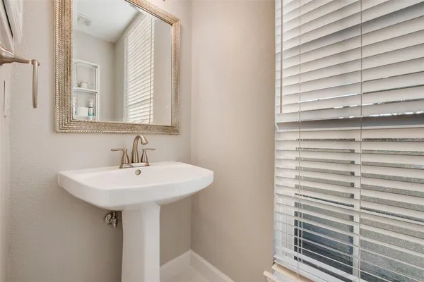 a bedroom with two beds and a lamp