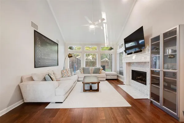a living room with furniture fireplace and flat screen tv