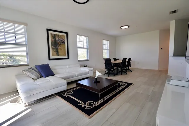 a living room with furniture rug and window