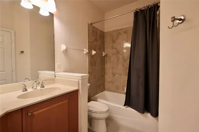 a bathroom with a sink a toilet a shower and a mirror