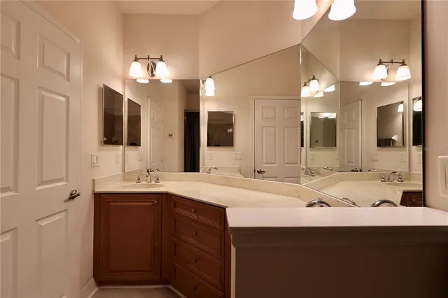 a bathroom with a sink double vanity granite and a mirror
