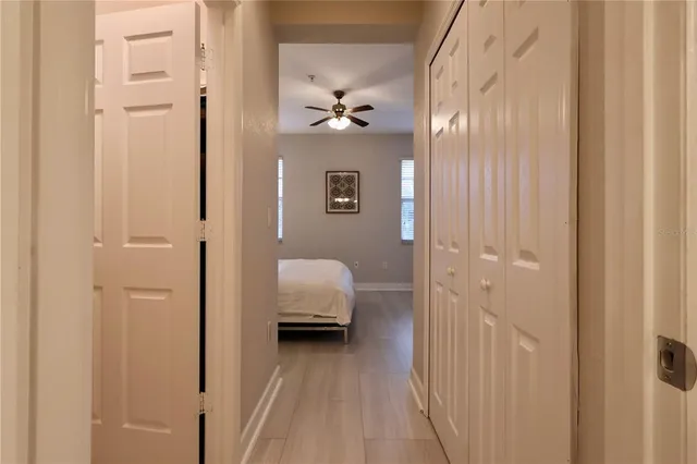 a view of a hallway with wooden floor and staircase