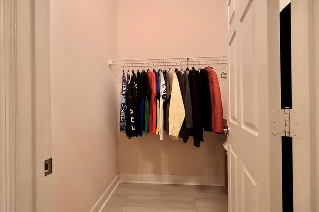 a view of walk in closet with clothes
