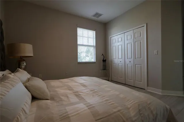 a bedroom with a bed and a window