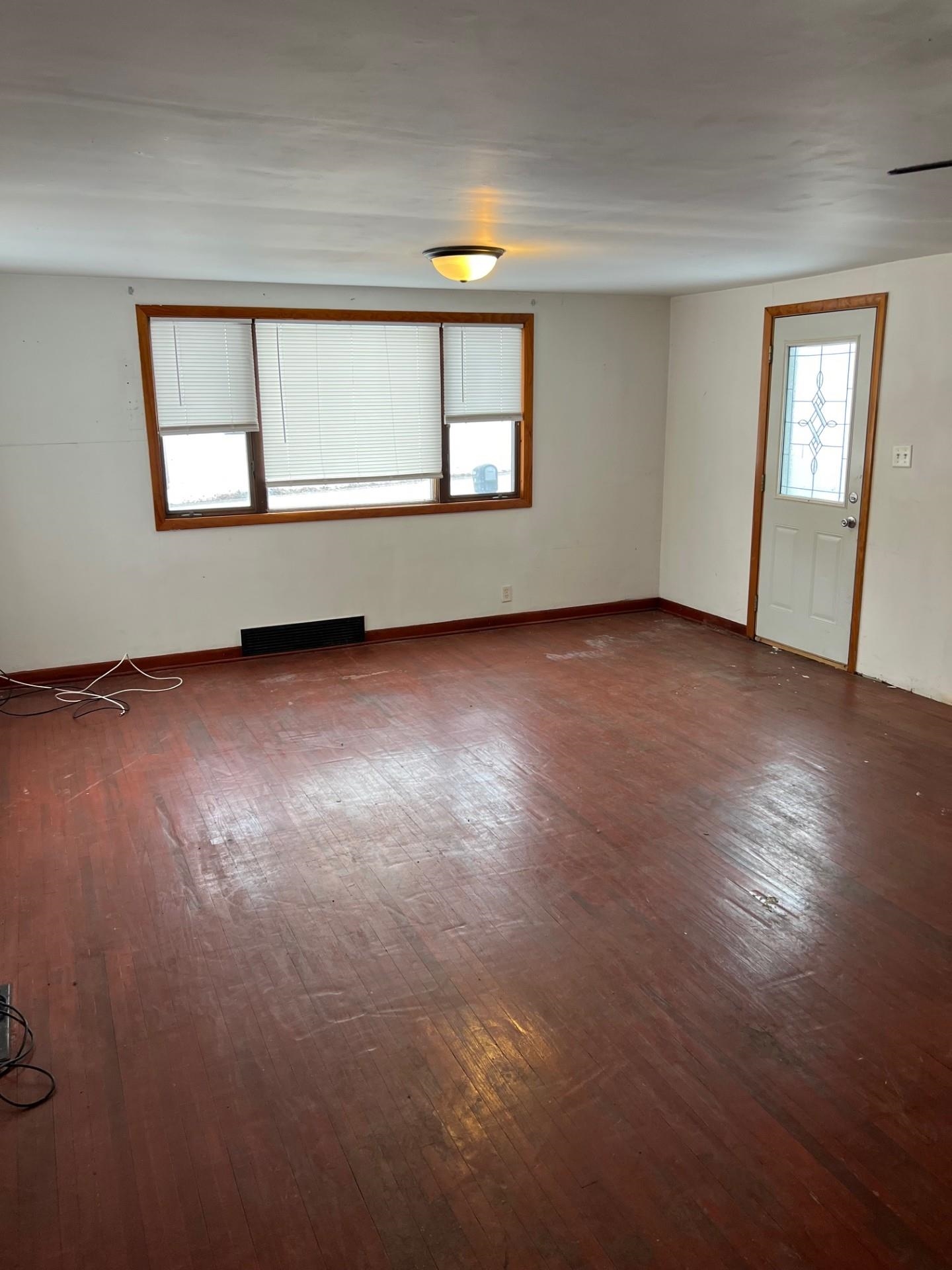 860 North Kent Road Kent, IL 61044 - Photo 2 of 11 an empty room with wooden floor and windows