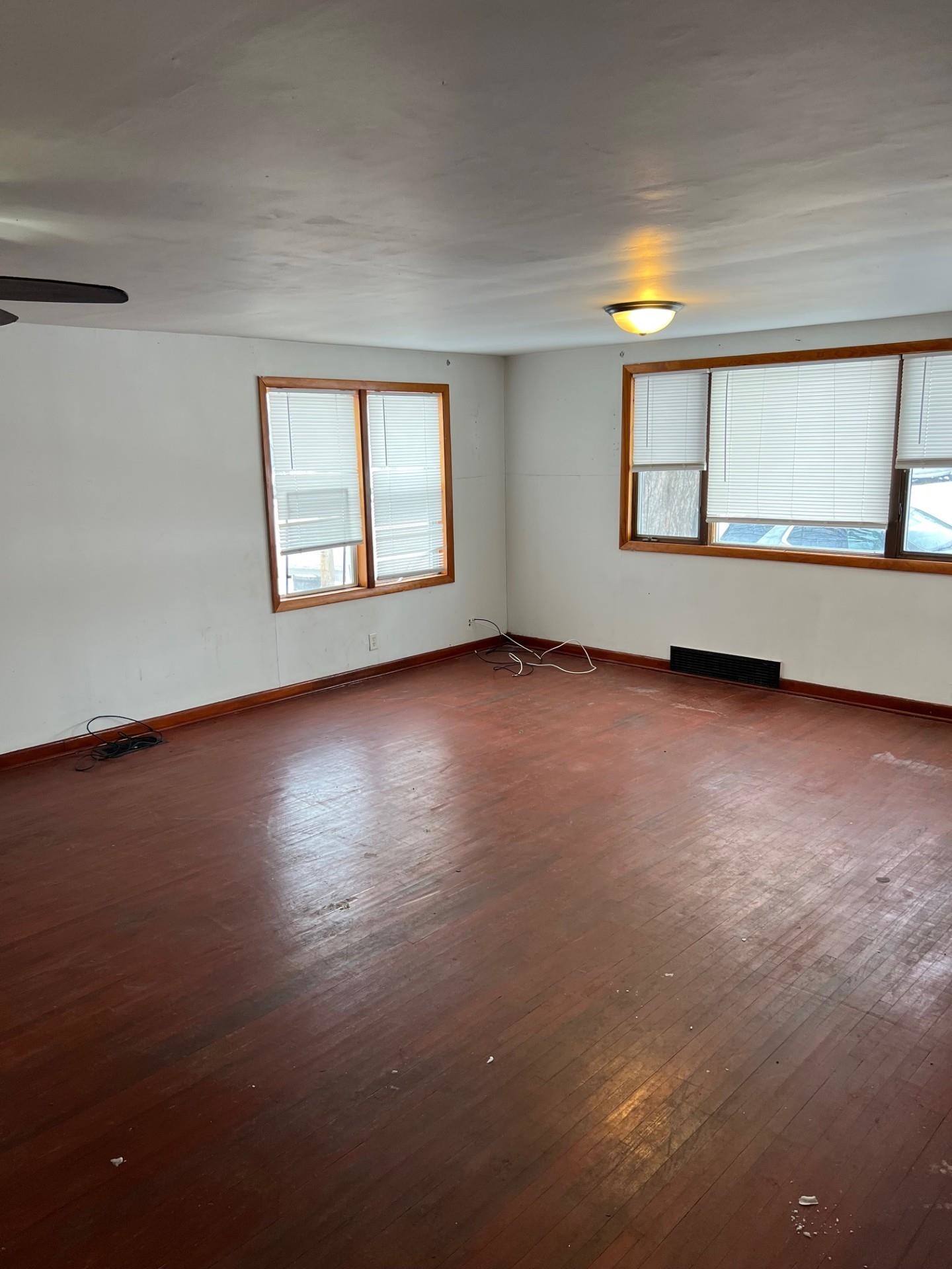 860 North Kent Road Kent, IL 61044 - Photo 3 of 11 a view of an empty room with a window and wooden floor