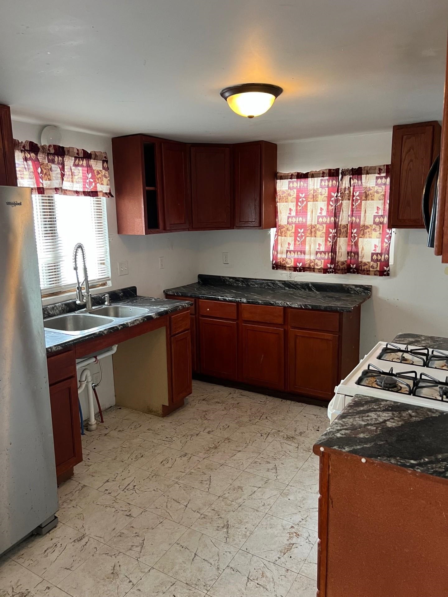 860 North Kent Road Kent, IL 61044 - Photo 5 of 11 a kitchen with a sink stove top oven and cabinets