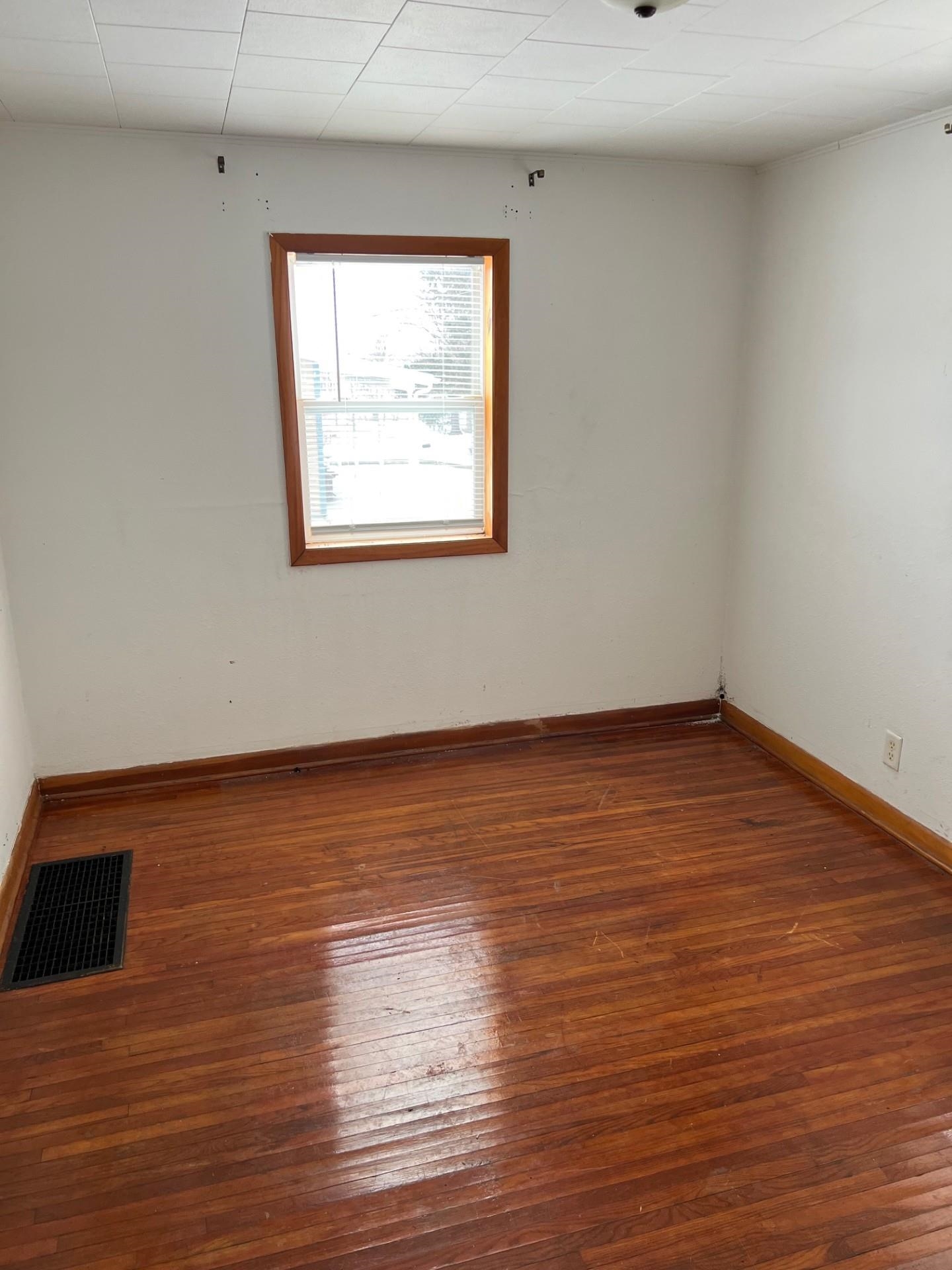 860 North Kent Road Kent, IL 61044 - Photo 7 of 11 a view of an empty room with wooden floor and a window