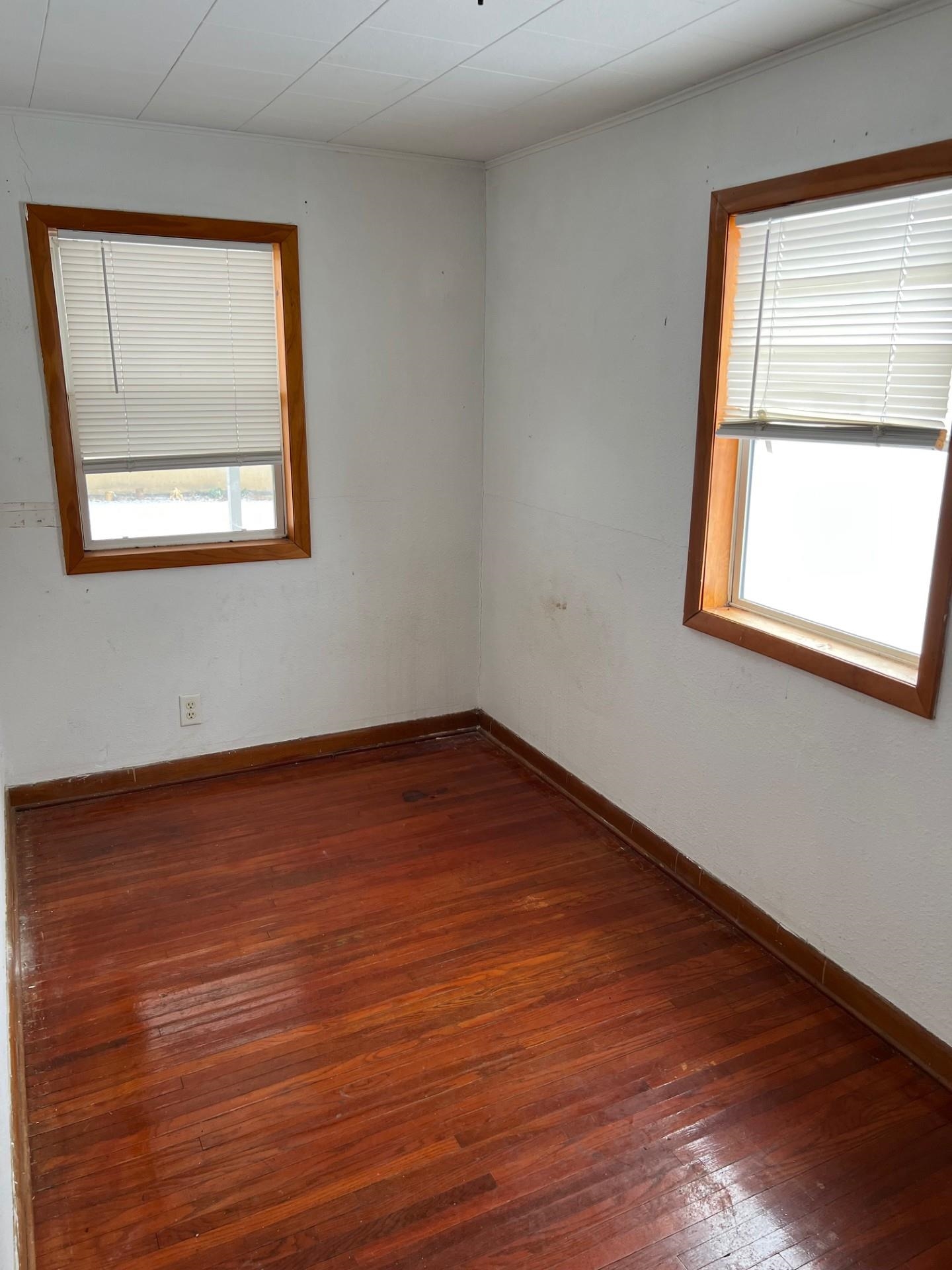 860 North Kent Road Kent, IL 61044 - Photo 8 of 11 an empty room with wooden floor and a window