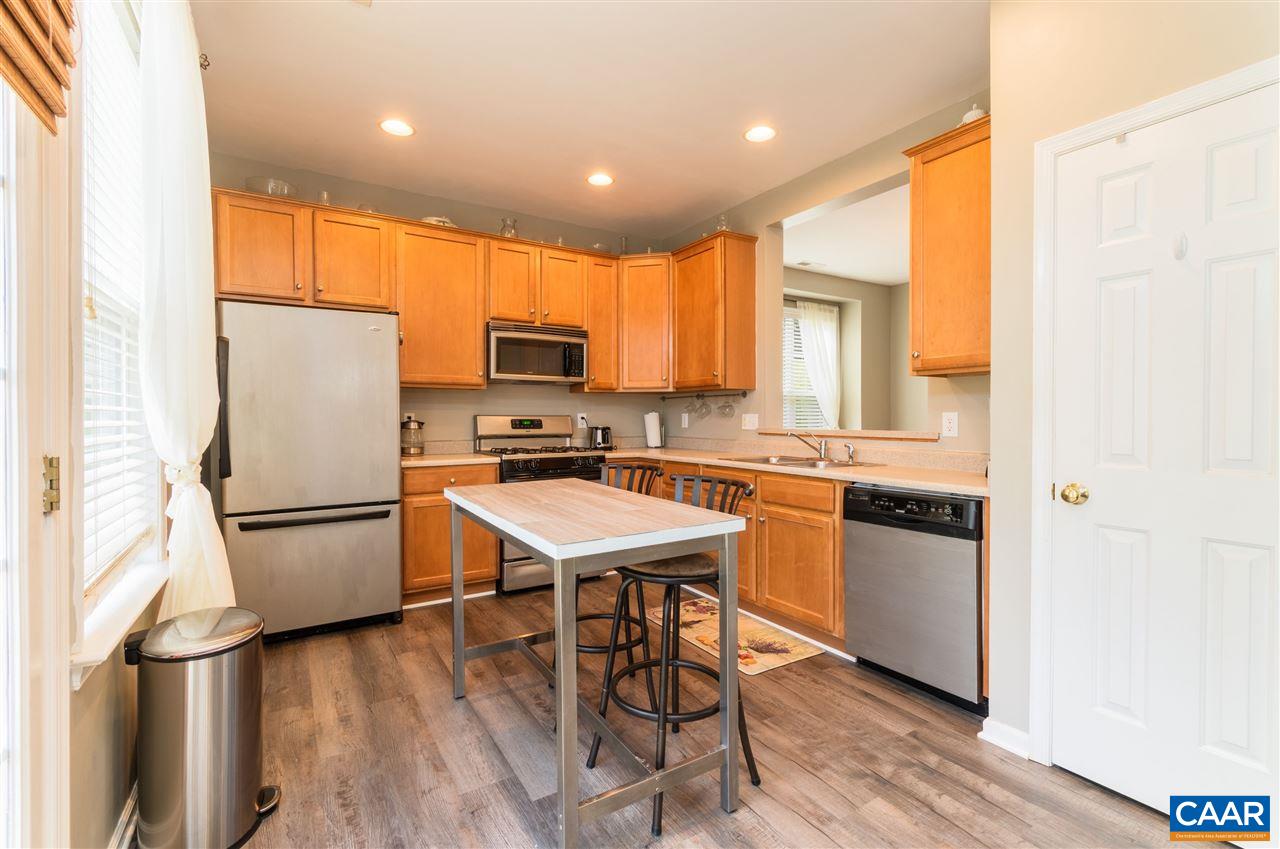 1366 Stoney Ridge Road Charlottesville, VA 22902 - Photo 13 of 33 a kitchen with a refrigerator a microwave a sink and a stove with wooden floor