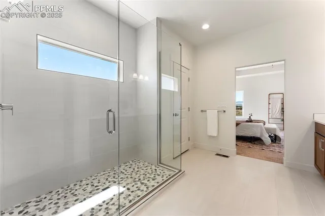 a bathroom with a granite countertop sink a shower and a mirror