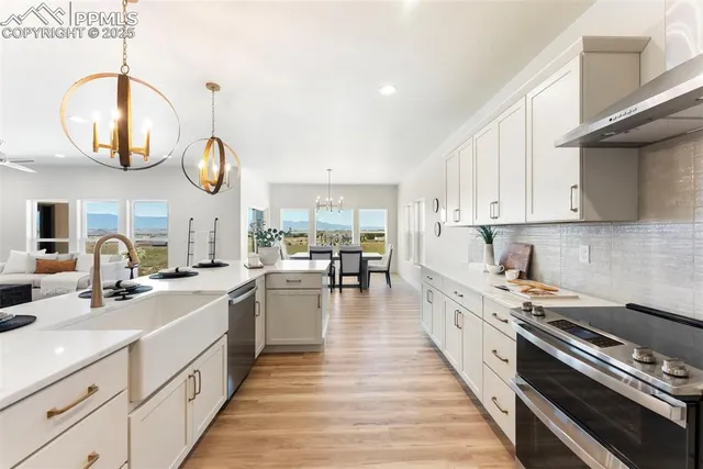 a kitchen with stove a sink and cabinets