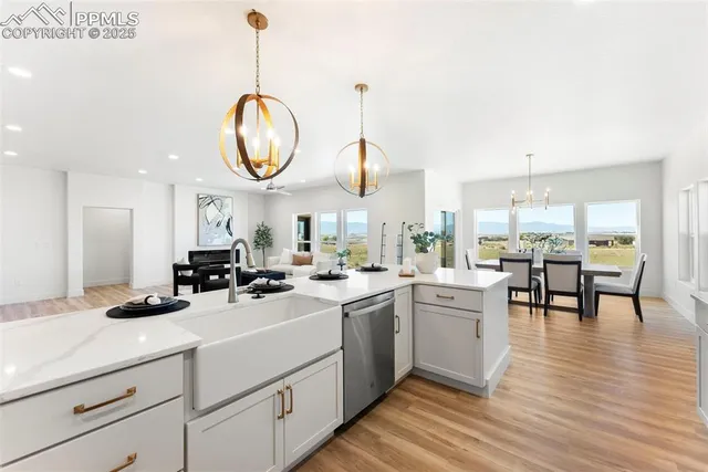 a kitchen with a sink cabinets and wooden floor