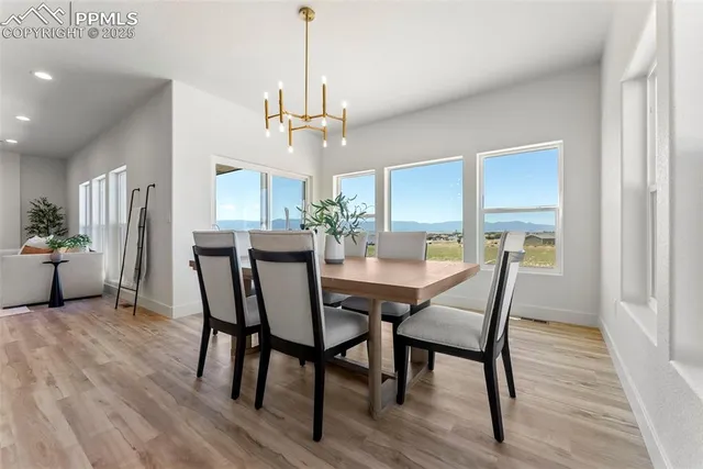 a view of a dining room with furniture window and wooden floor