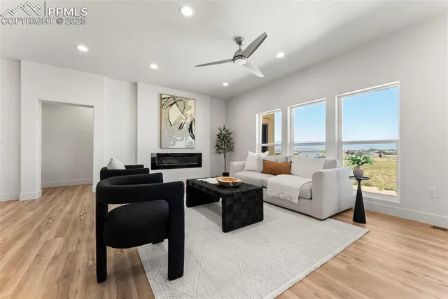 a living room with furniture and a large window