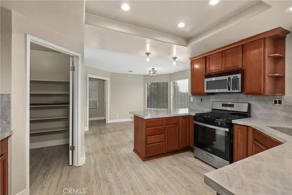 a kitchen with stainless steel appliances granite countertop a stove top oven and sink