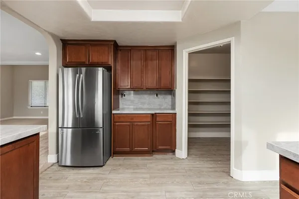 a kitchen with stainless steel appliances granite countertop a refrigerator and a sink