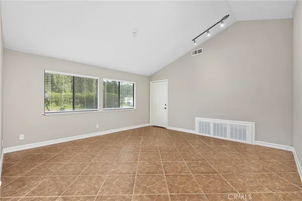 an empty room with windows and closet