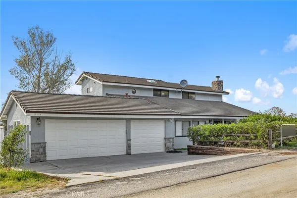 a view of a house with a street