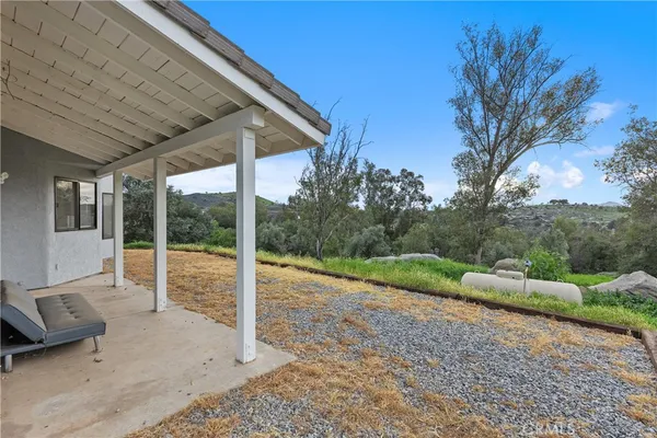 a backyard of a house with a table and chairs