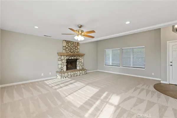 a view of an empty room with a fireplace